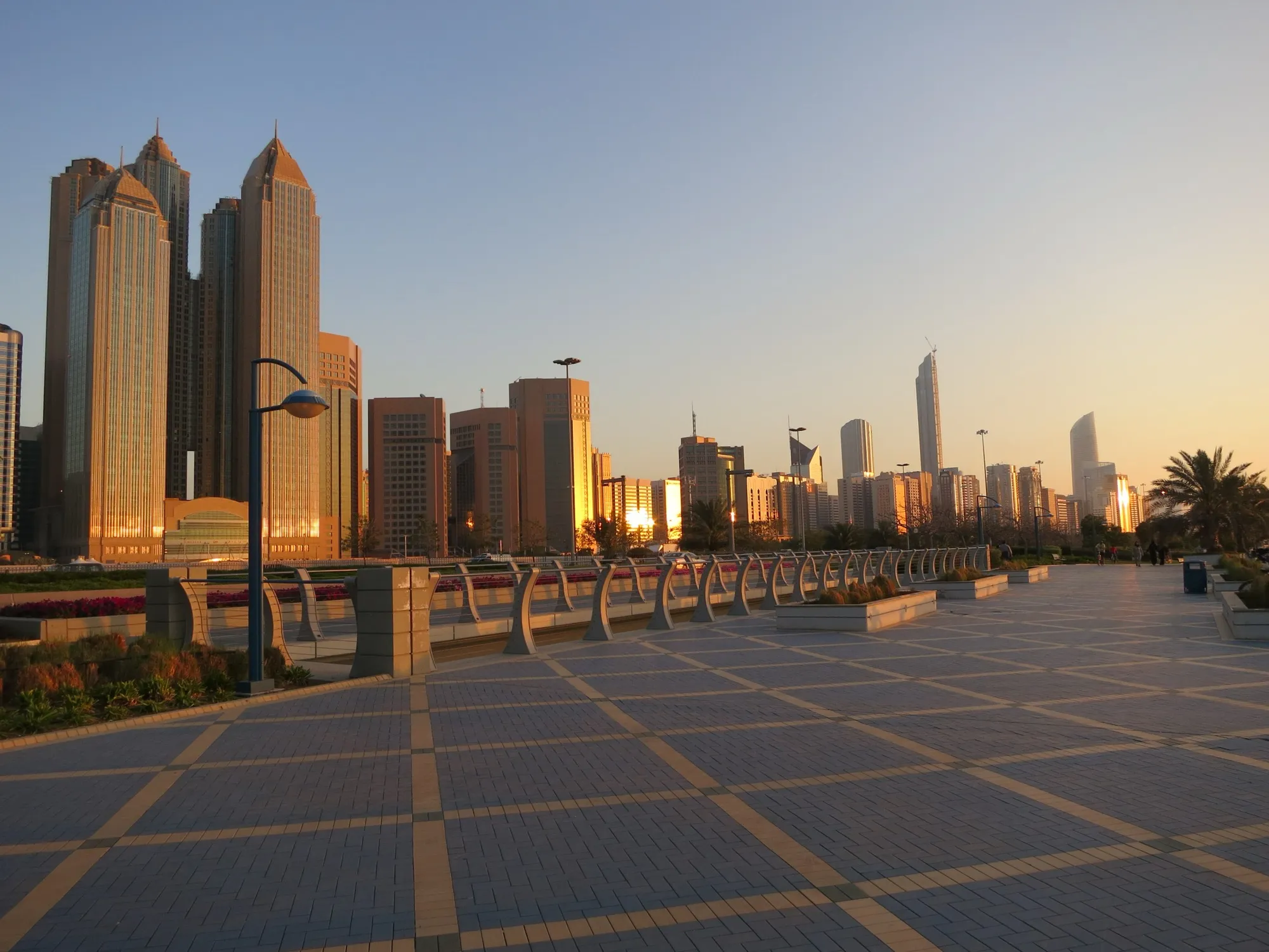 The Abu Dhabi skyline at sunset, seen from the Corniche promenade