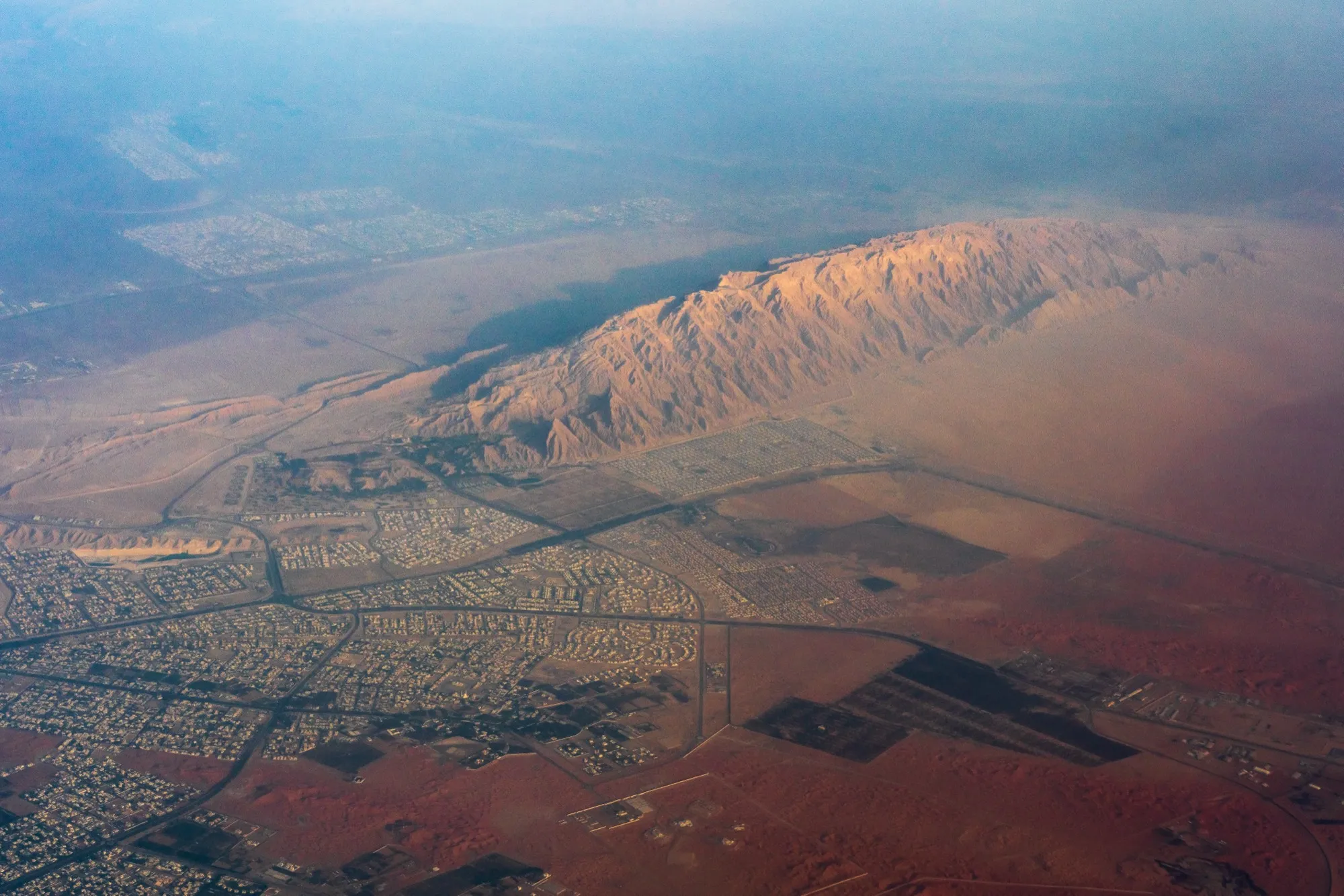 Aerial view of the Jebel Hafeet ridge rising above the suburbs of Al Ain