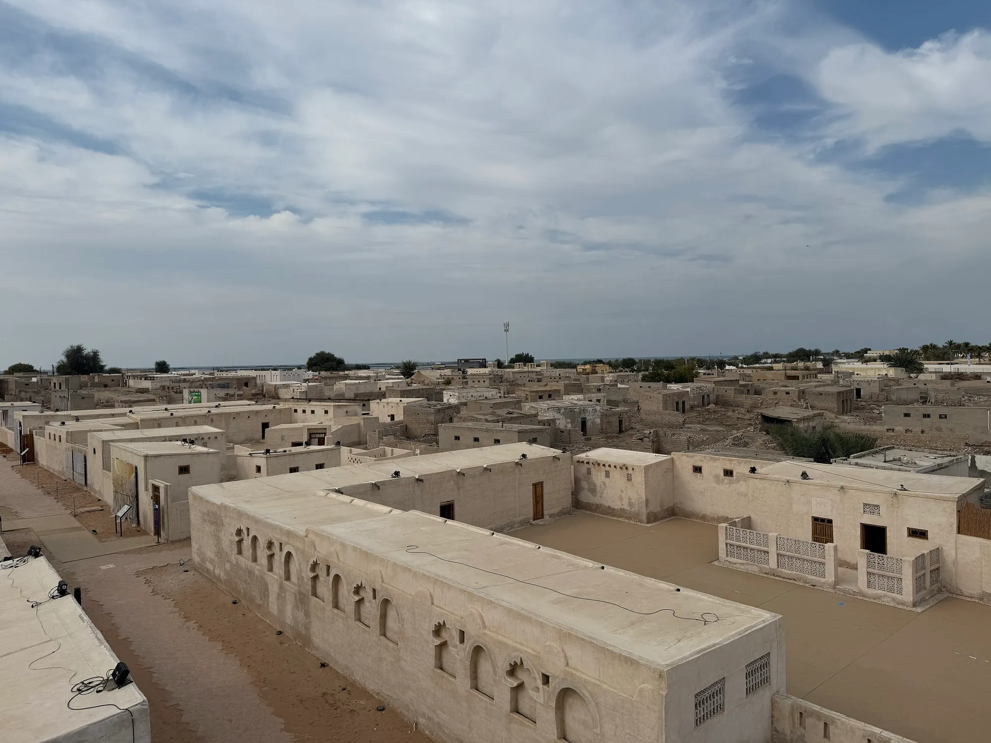 Restored and ruined courtyard houses in the old pearling village of Al Jazirah Al Hamra