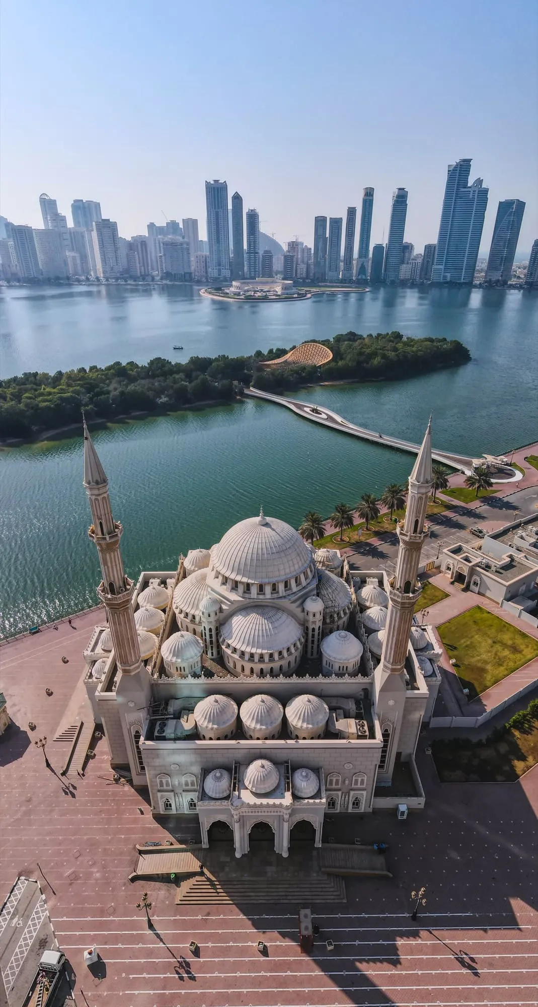 Al Noor Mosque seen from above, with Al Noor Island and the Sharjah skyline across Khalid Lagoon