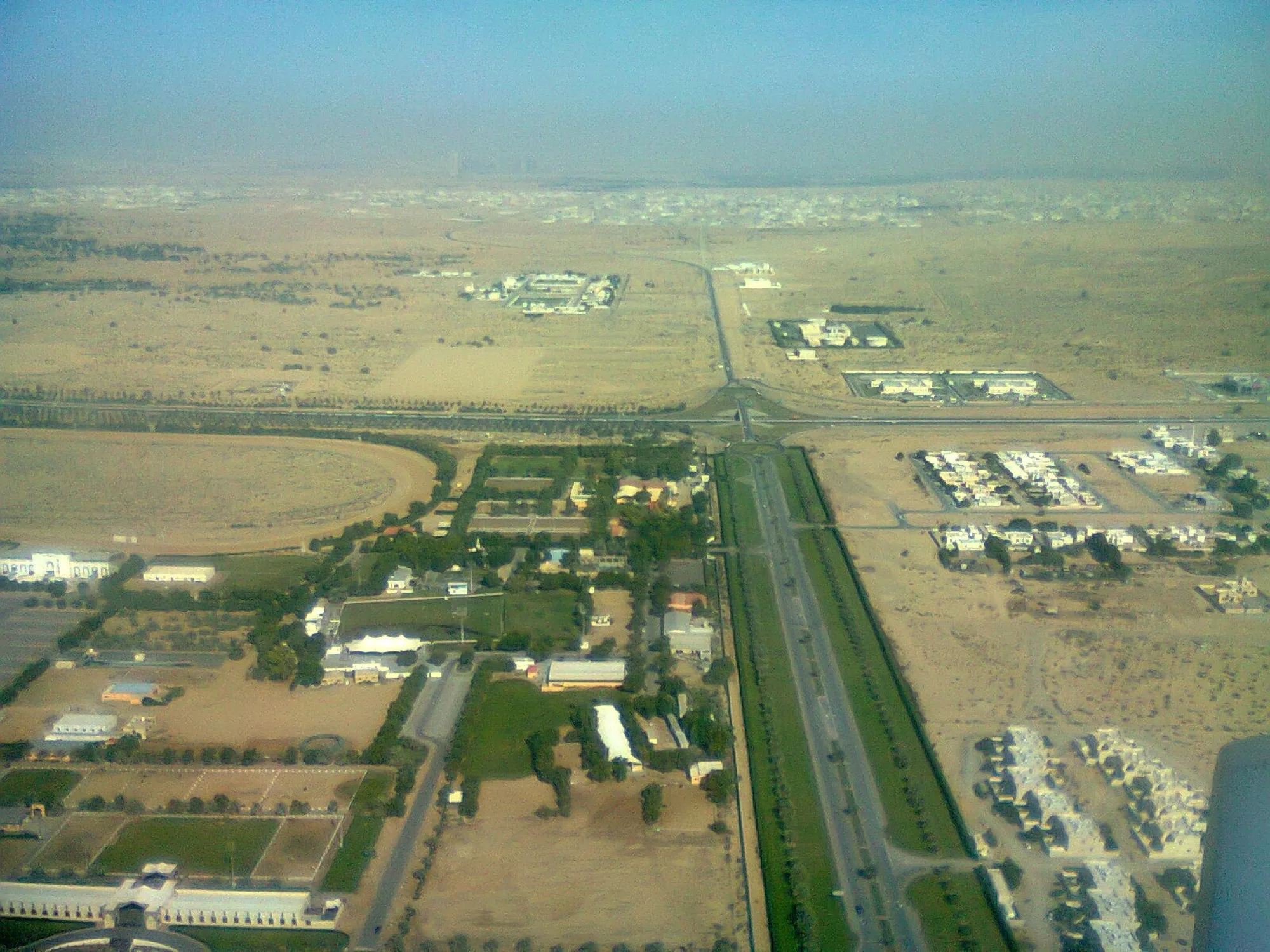 Aerial view of the roads and low-rise suburbs around Sharjah International Airport