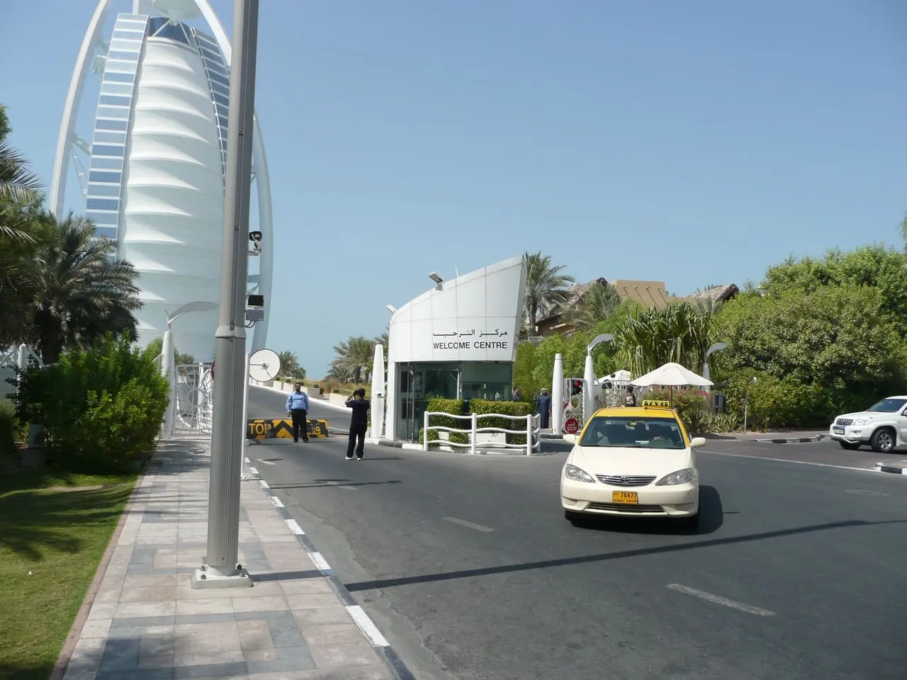 The approach road to the Burj Al Arab in Dubai, with the welcome centre gatehouse and a taxi