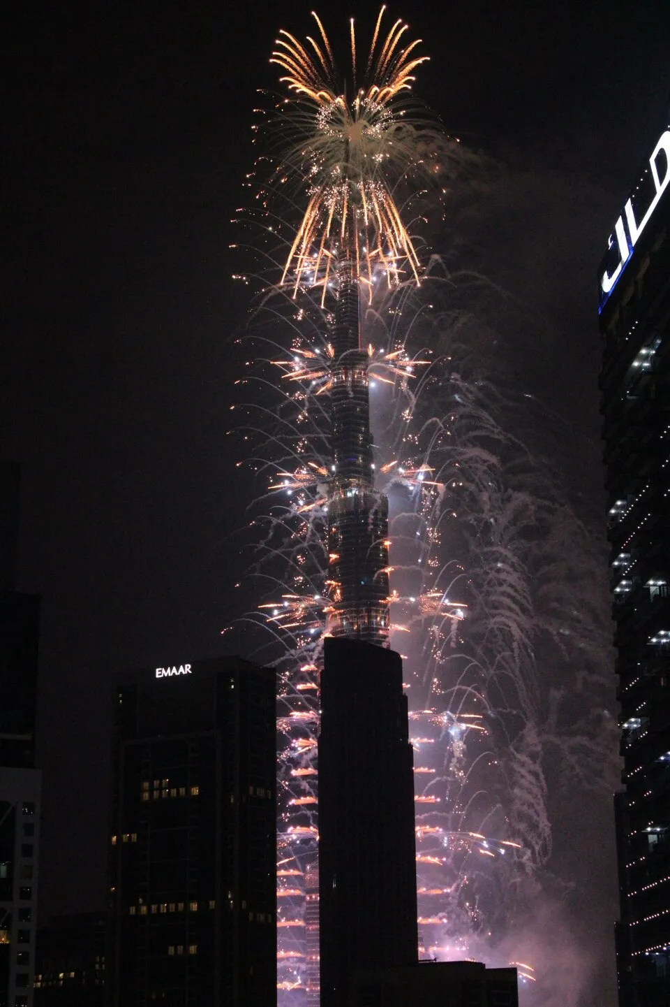 Fireworks cascading down Burj Khalifa at night in Downtown Dubai