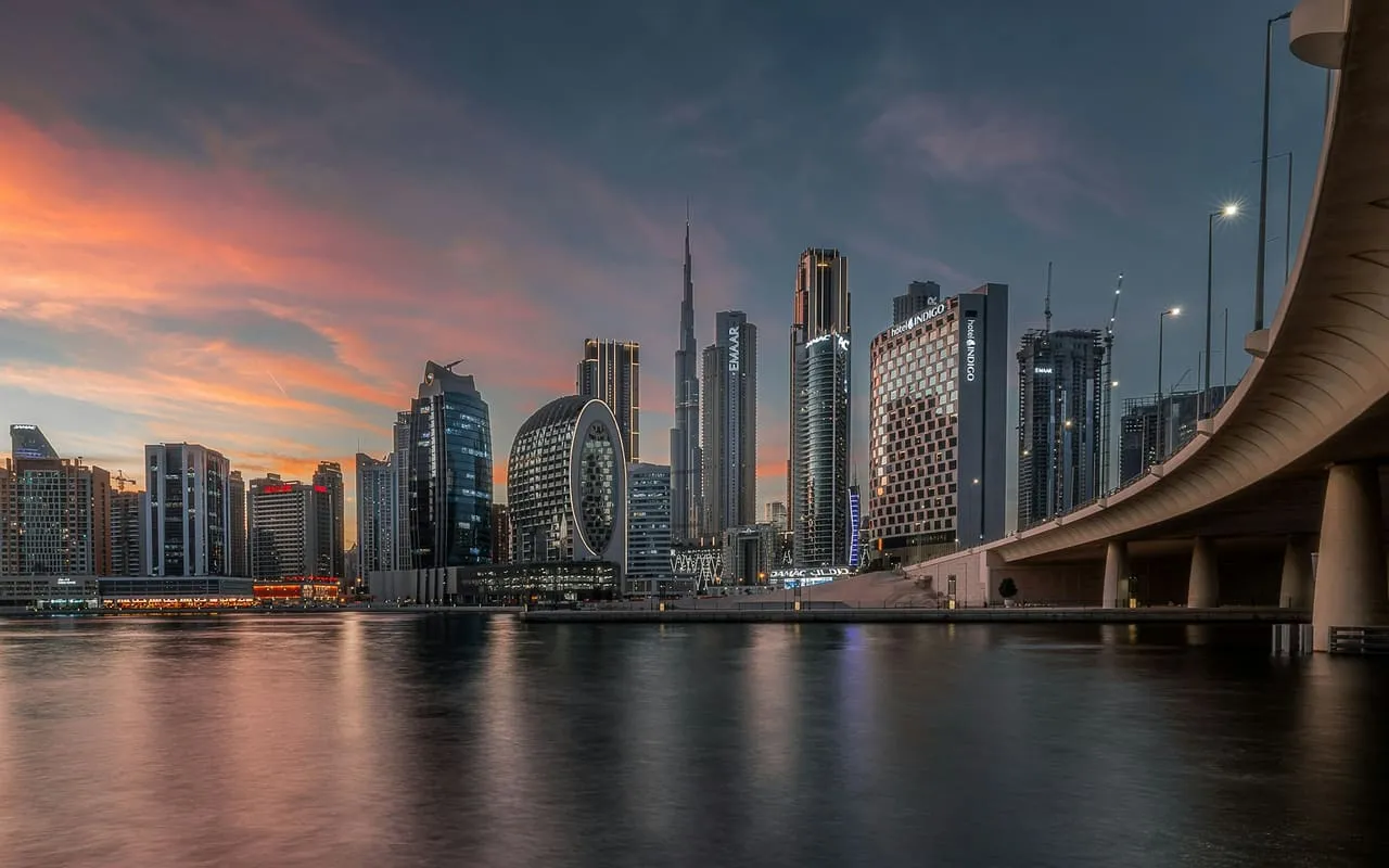 Business Bay towers and the Burj Khalifa across the Dubai Water Canal at sunset