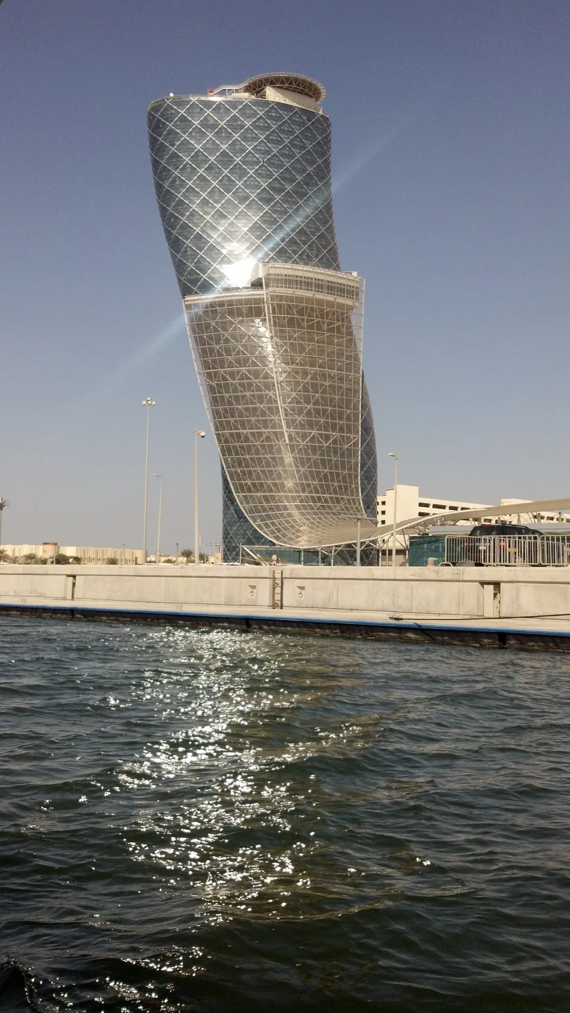 The leaning Capital Gate tower at ADNEC Centre Abu Dhabi, seen from the water