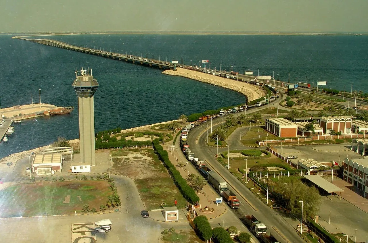 Lorries queuing at the Saudi and Bahrain border zone on the King Fahd Causeway, beside the causeway tower, photographed in 2007