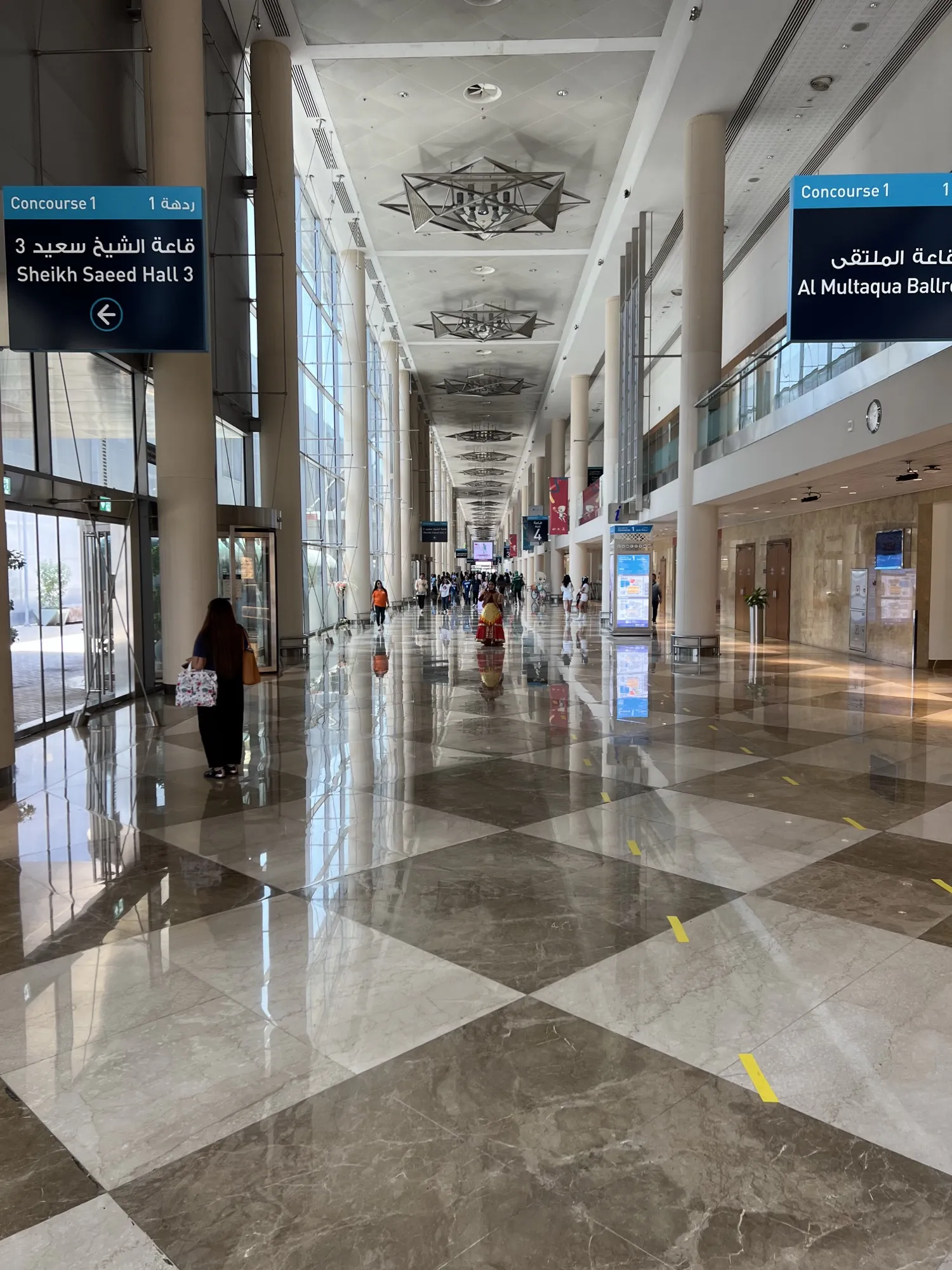 Concourse 1 inside Dubai World Trade Centre, with signs to Sheikh Saeed Hall 3