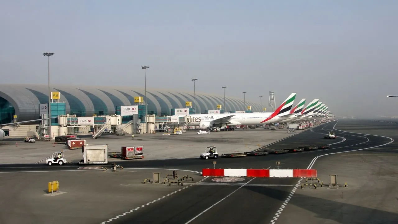 Emirates aircraft lined up at the gates of Dubai International Airport