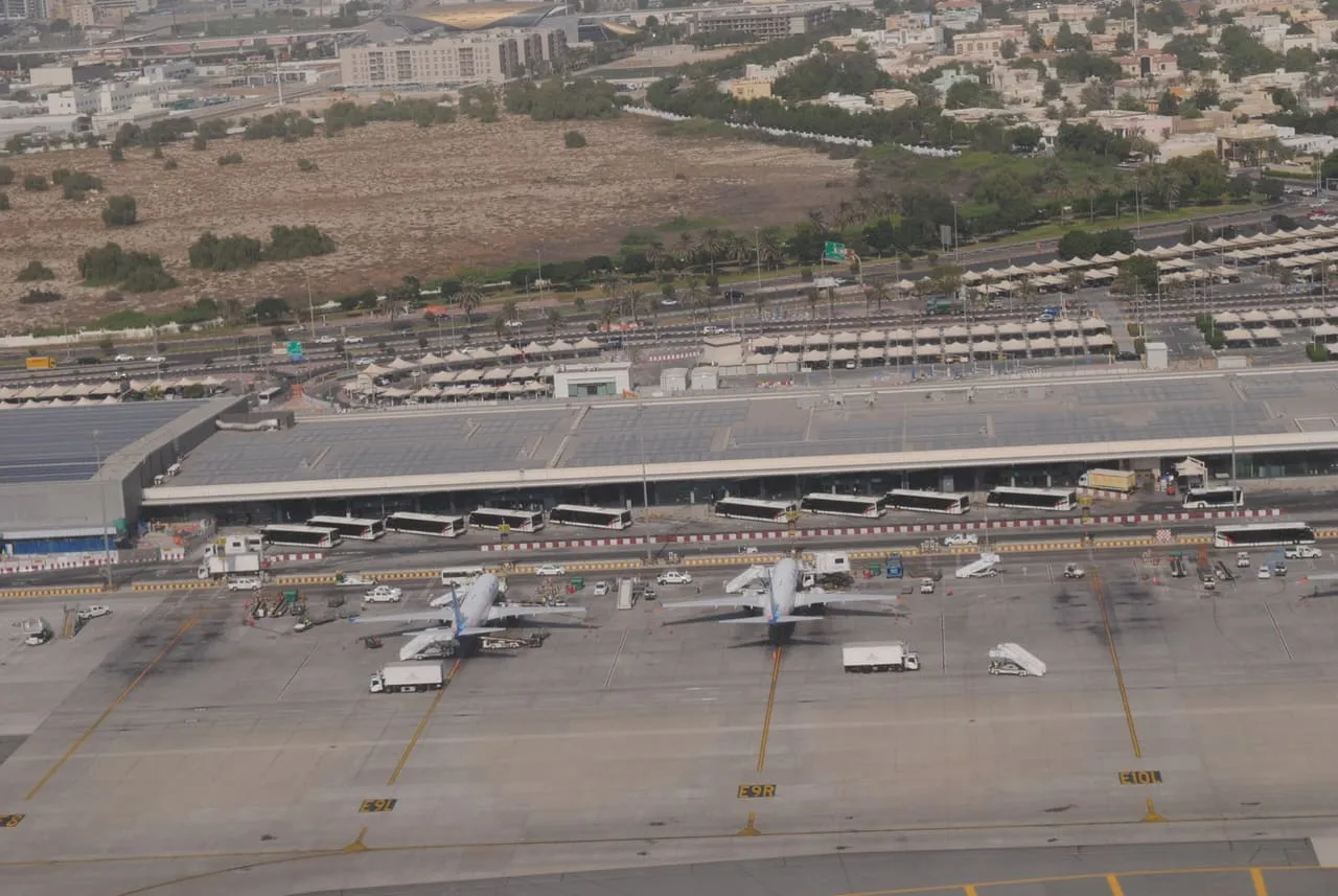 Dubai International Airport Terminal 2 and its apron, seen from an aircraft coming in to land