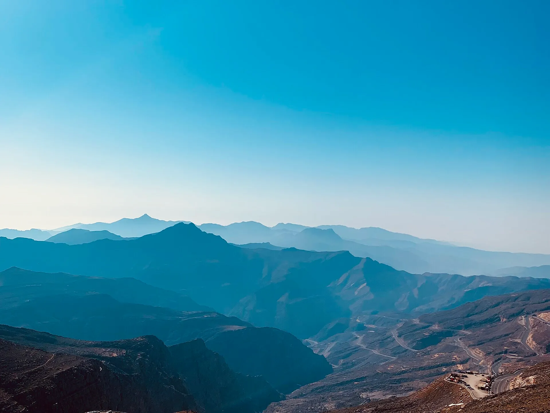 Ridges of the Hajar Mountains fading into haze, seen from high on Jebel Jais