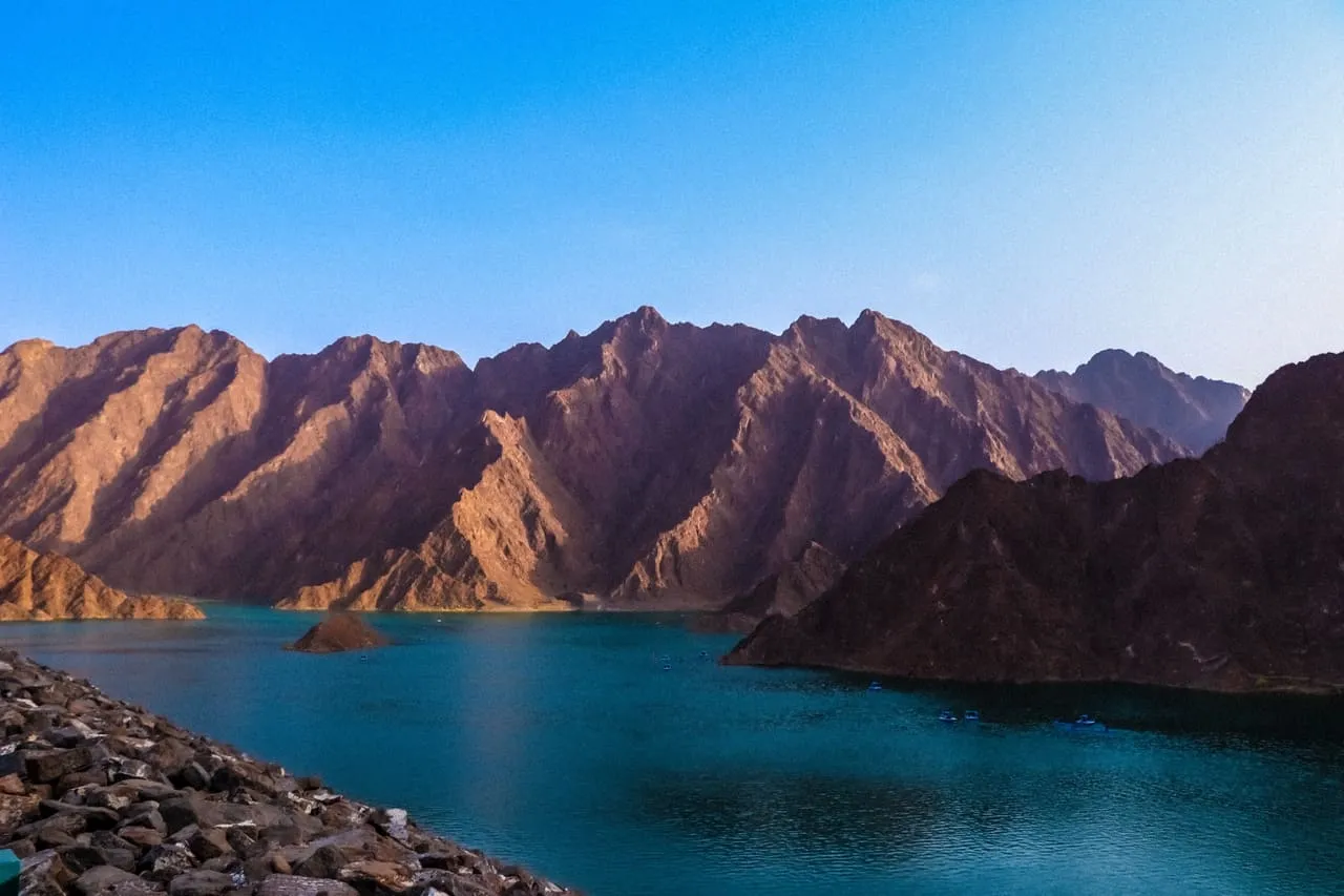 The turquoise reservoir at Hatta Dam, ringed by the bare rock of the Hajar Mountains