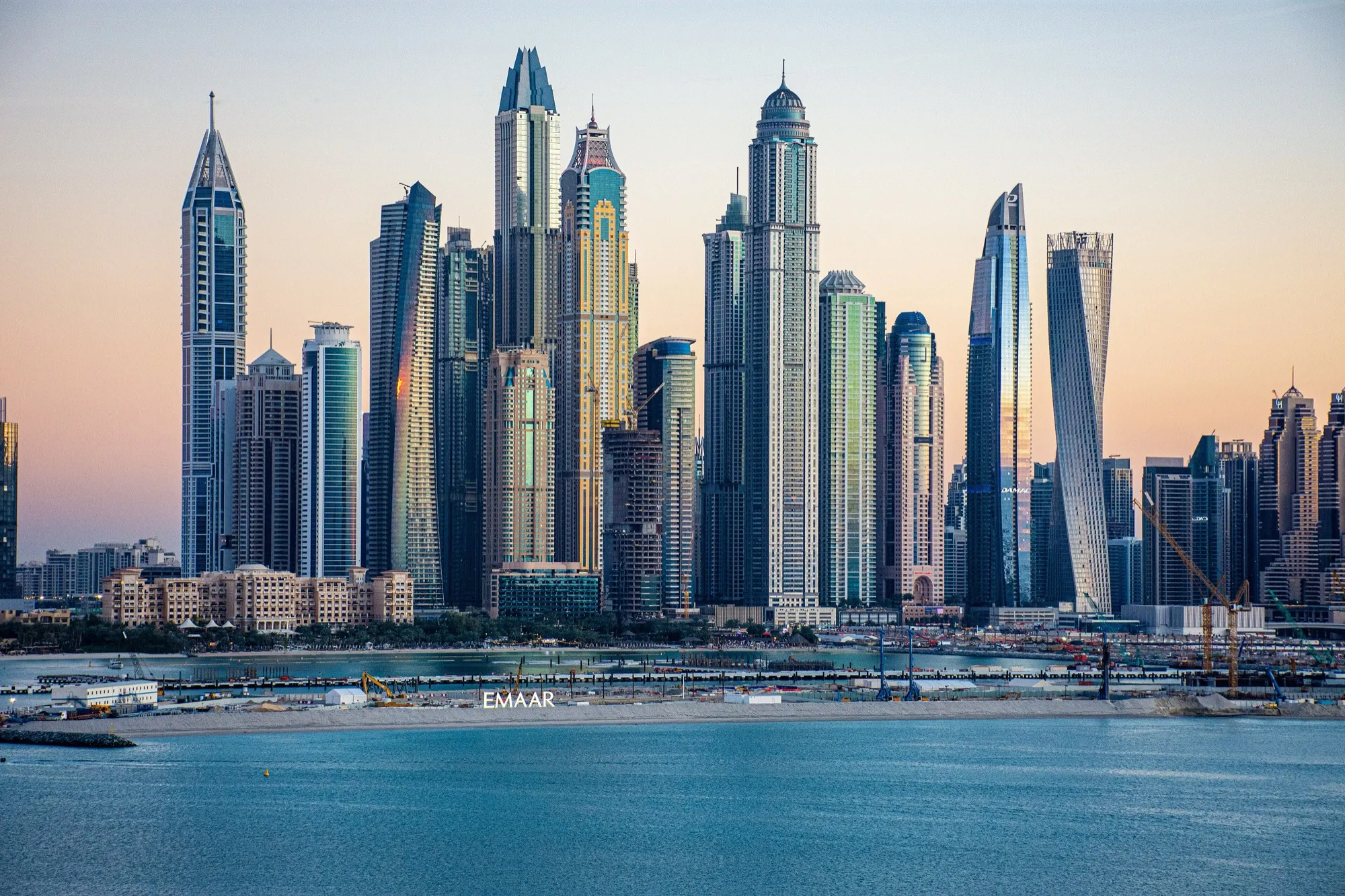 The towers of Dubai Marina at sunset seen across the water