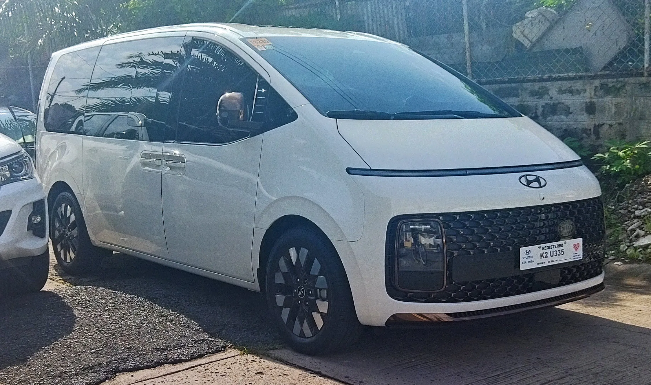 A white Hyundai Staria people mover parked on a street