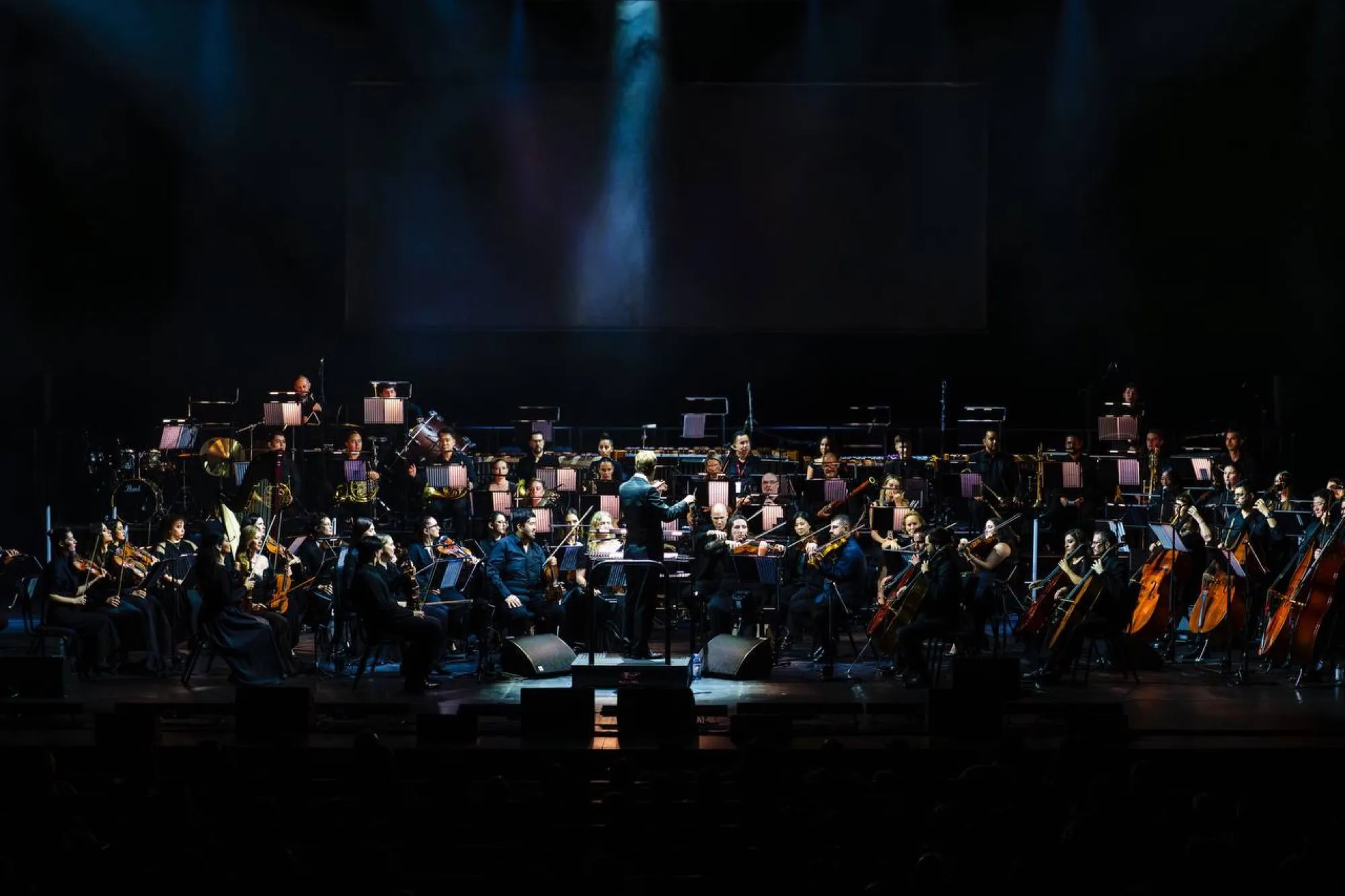 The UAE Philharmonic Orchestra playing on the stage at Dubai Opera in Downtown Dubai