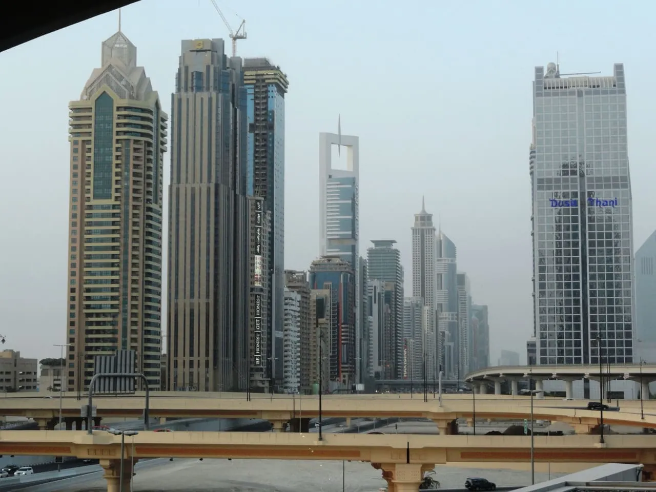 Towers along Sheikh Zayed Road in Dubai, behind a flyover interchange