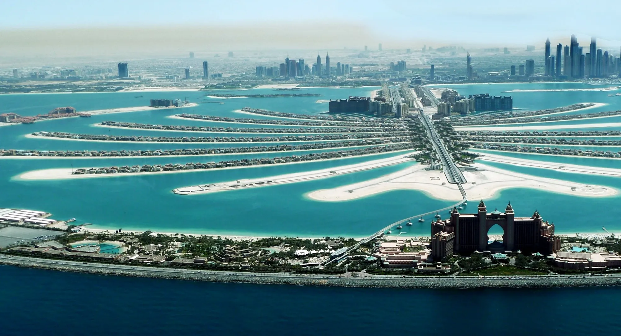 Palm Jumeirah from the air, with Atlantis on the outer crescent and the Dubai Marina towers behind