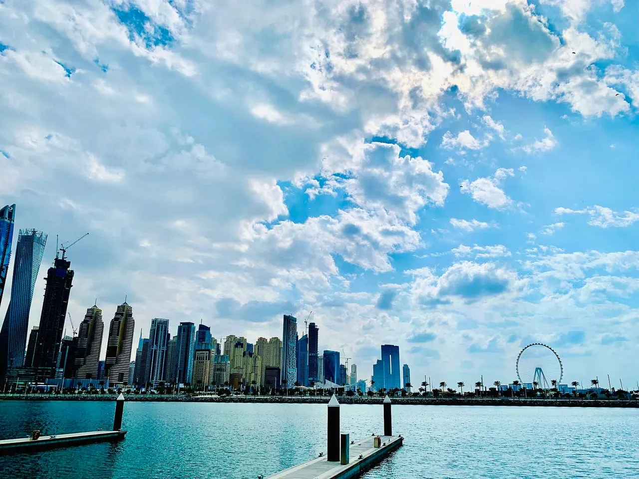 Dubai Marina's towers and the Ain Dubai wheel across the water from Dubai Harbour