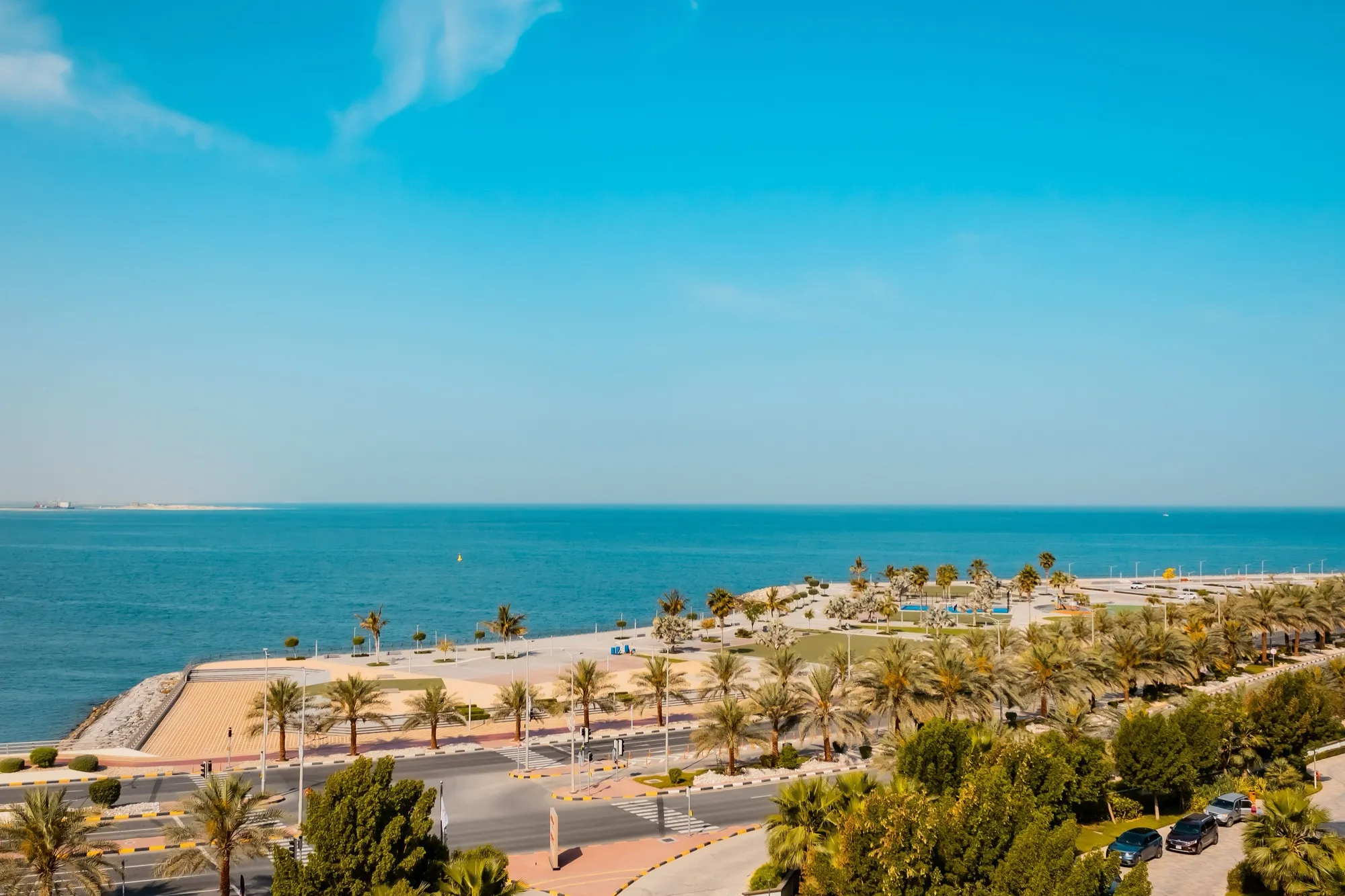 The Ras Al Khaimah seafront with palm-lined promenade and the Gulf beyond