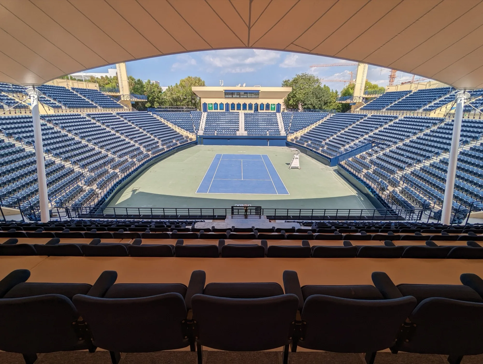 Centre court and empty blue seating at the Dubai Duty Free Tennis Stadium in Al Garhoud, seen from the south stand