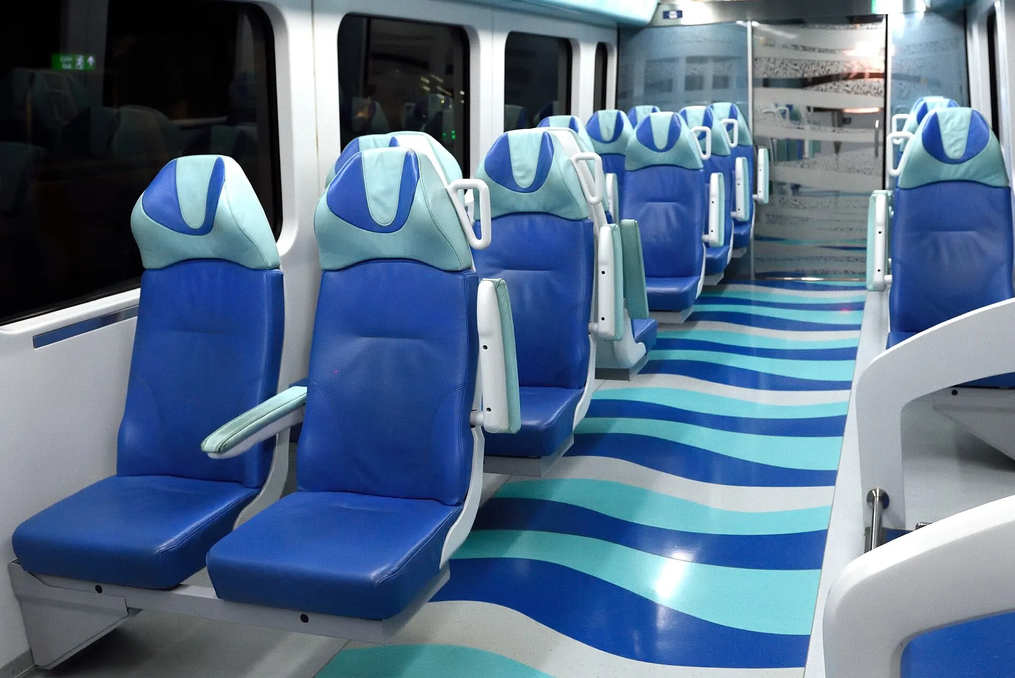 Blue leather seats and a wave-pattern floor inside a Gold Class Dubai Metro cabin