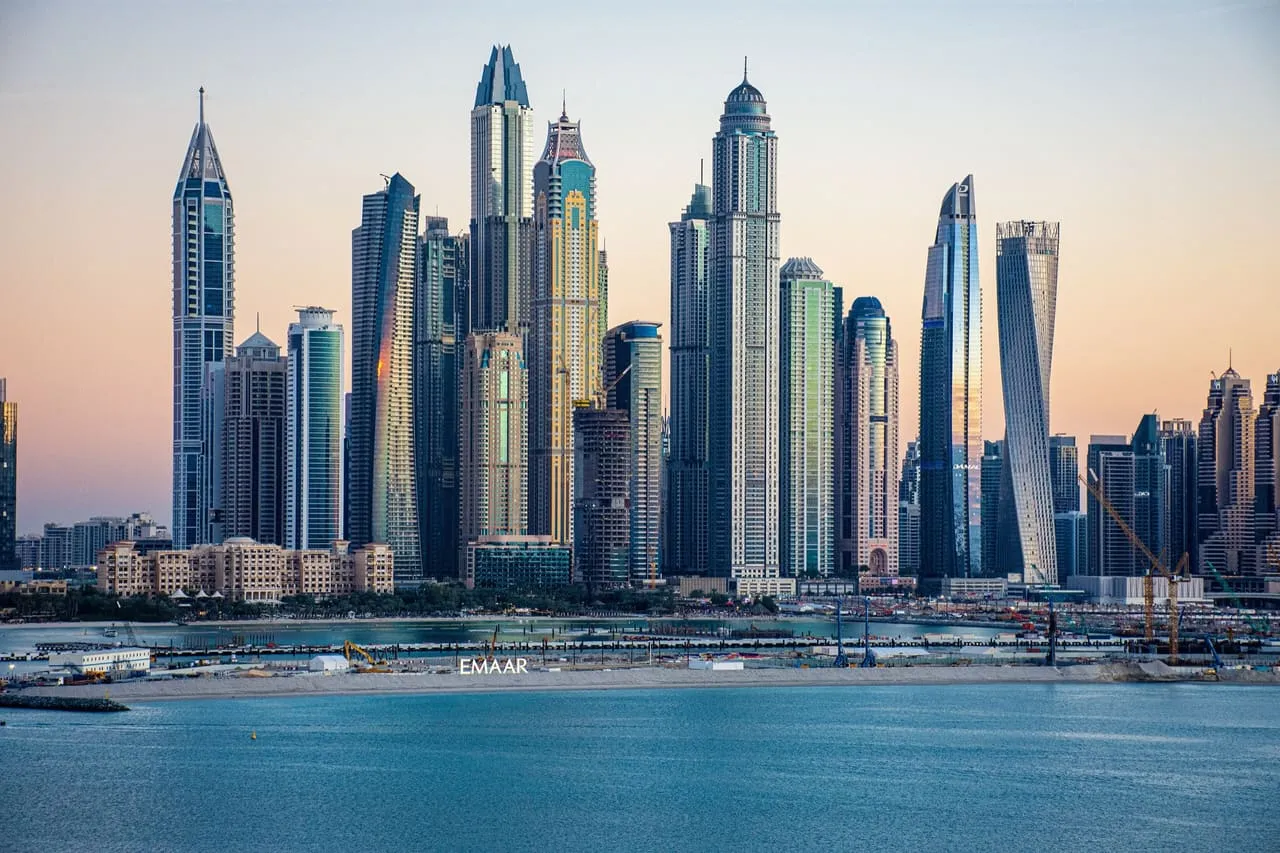 The towers of Dubai Marina across the water at dusk