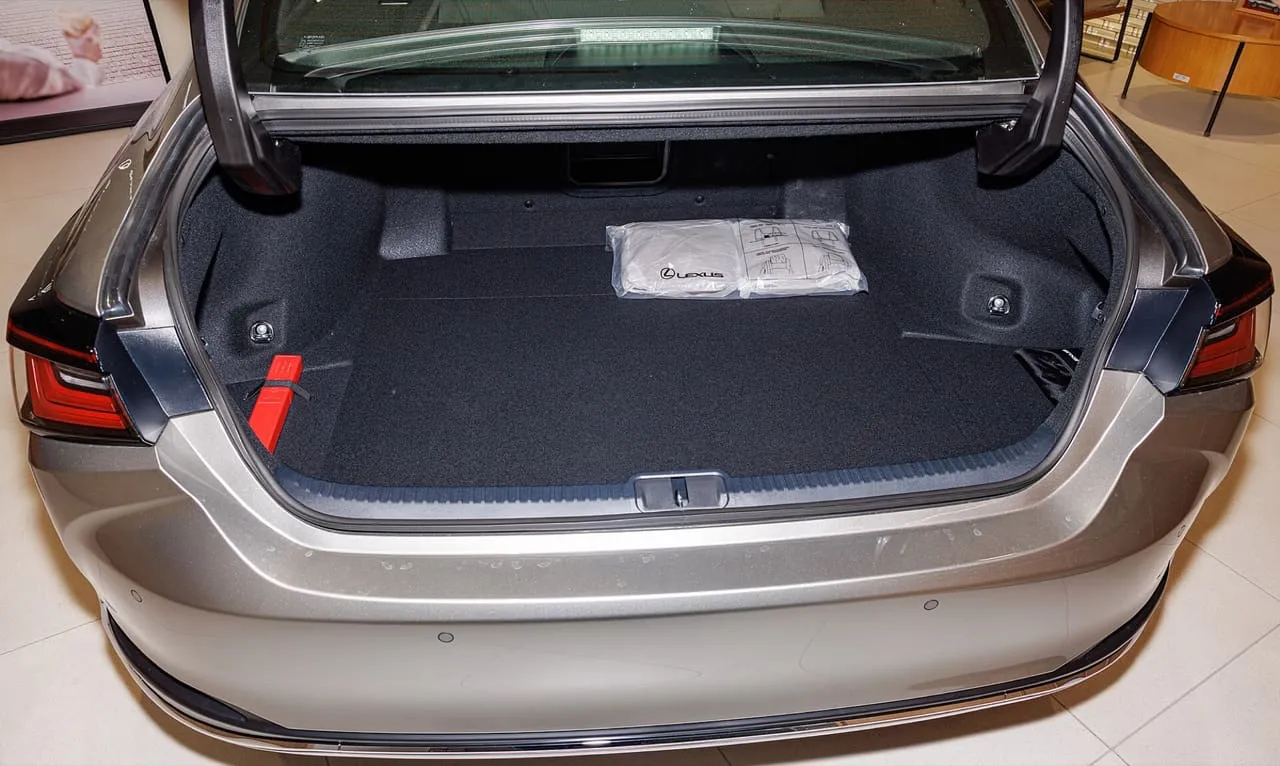 The open, empty boot of a Lexus ES 300h sedan with the boot lid raised