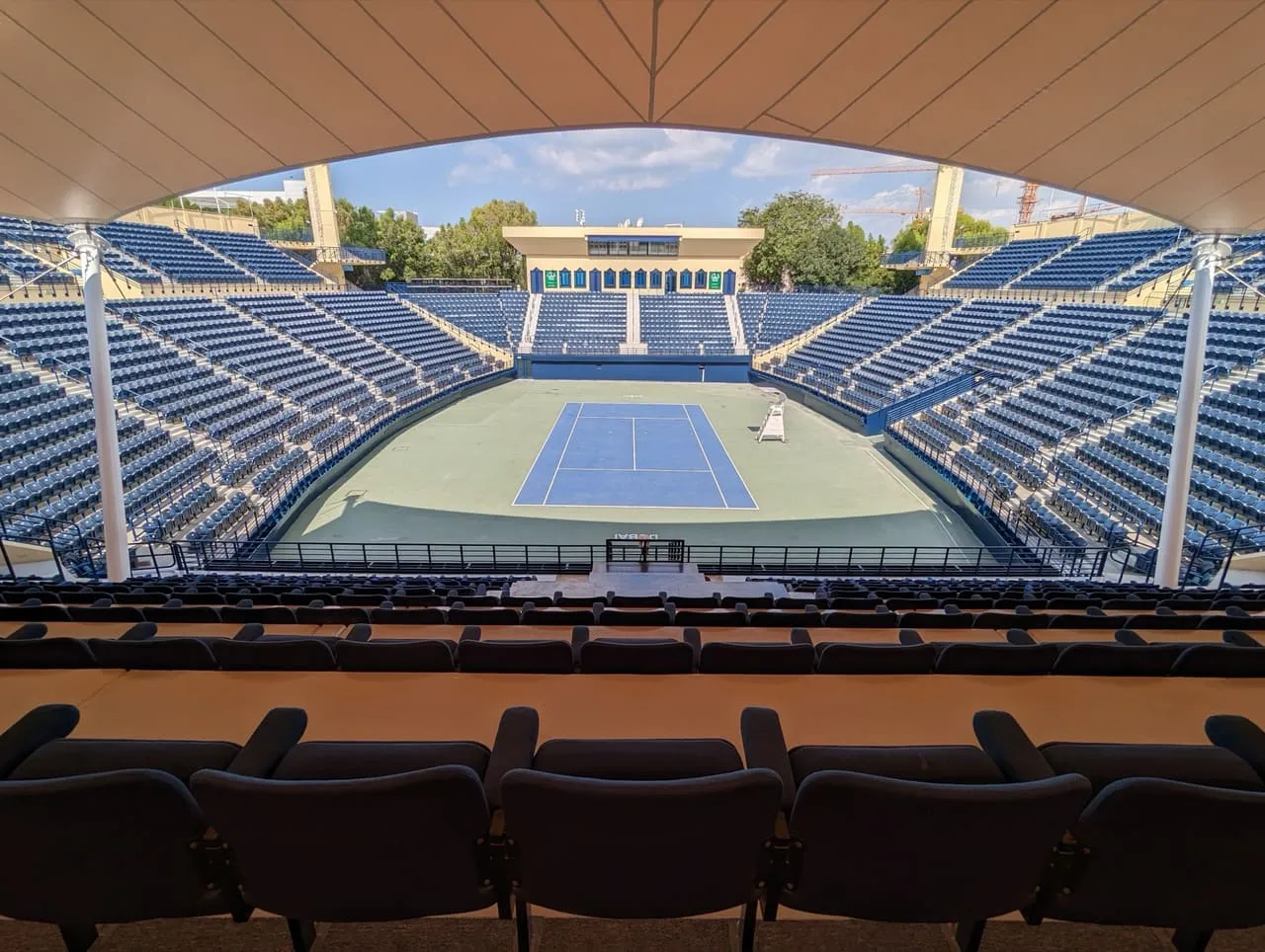 Centre court and empty blue seating at the Dubai Duty Free Tennis Stadium in Al Garhoud, seen from the south stand