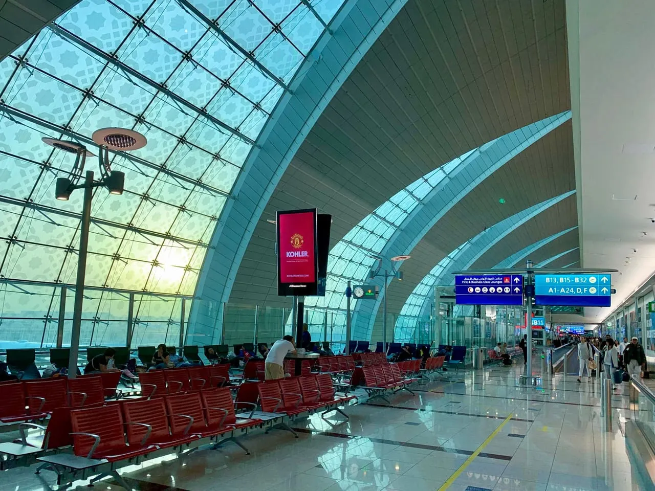 Gate seating under the arched glass roof of Terminal 3 at Dubai International Airport
