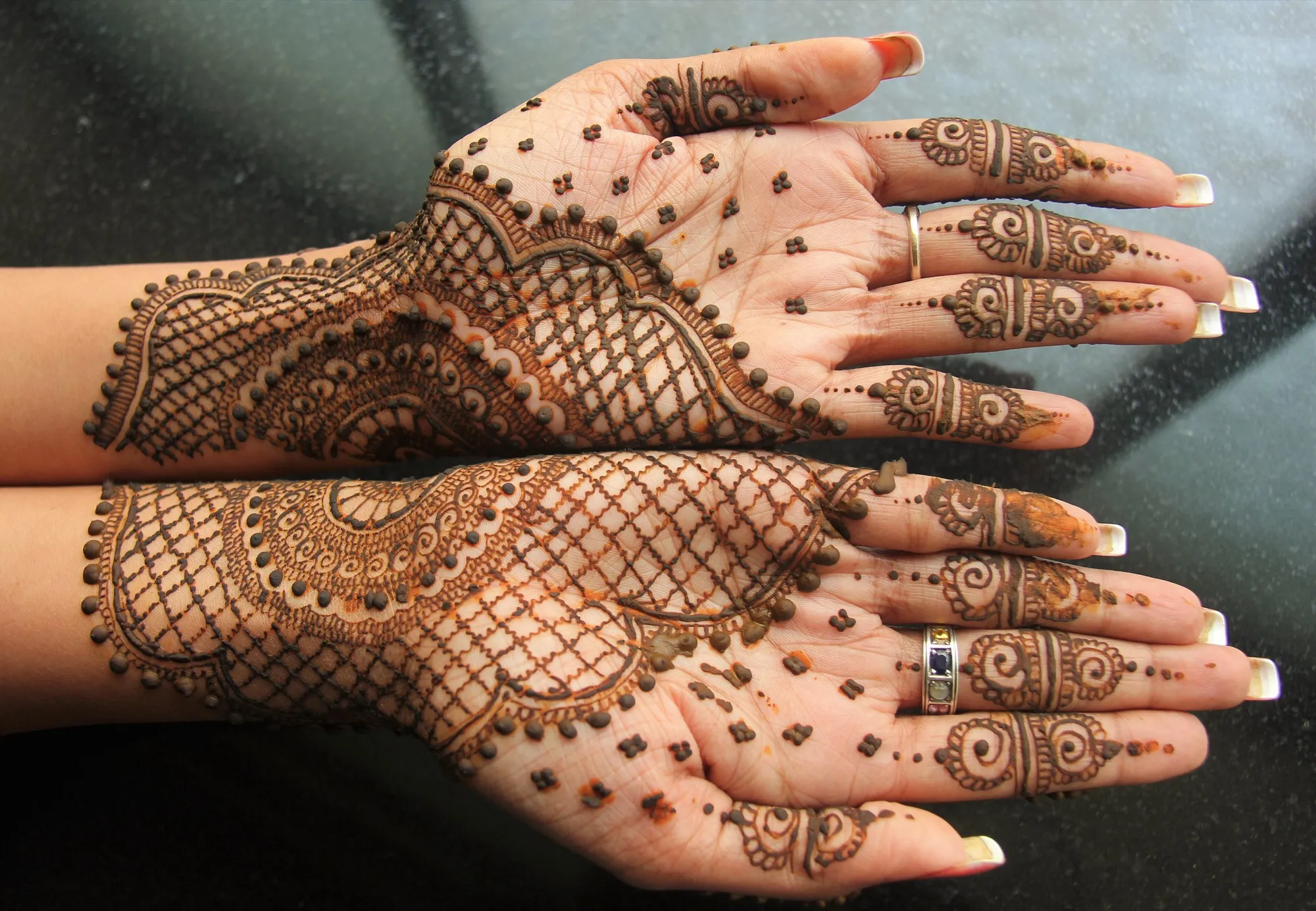 Henna patterns on a pair of hands, the kind of design applied at a mehndi night