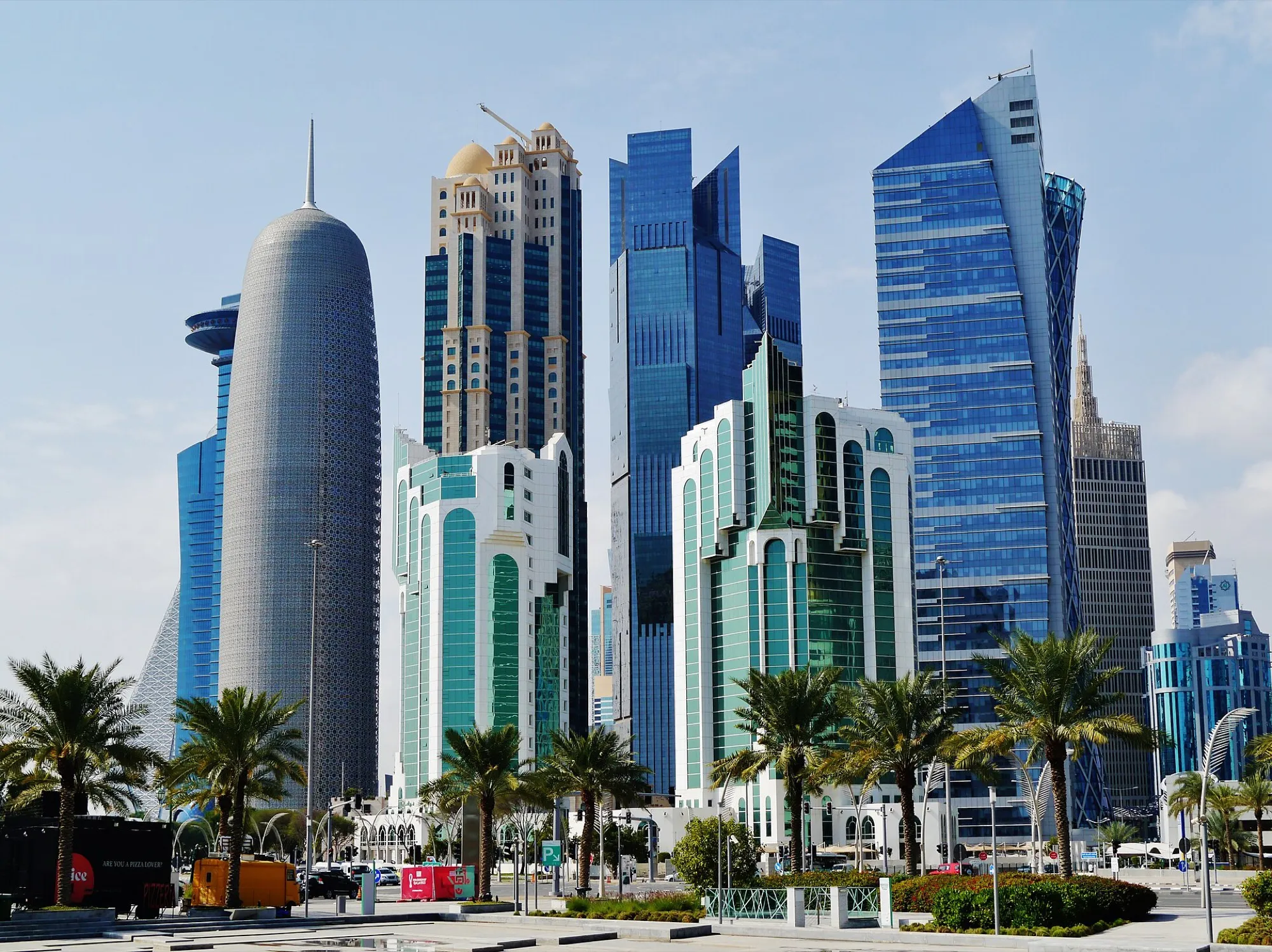 Towers of the West Bay skyline in Doha, Qatar, with palms in the foreground