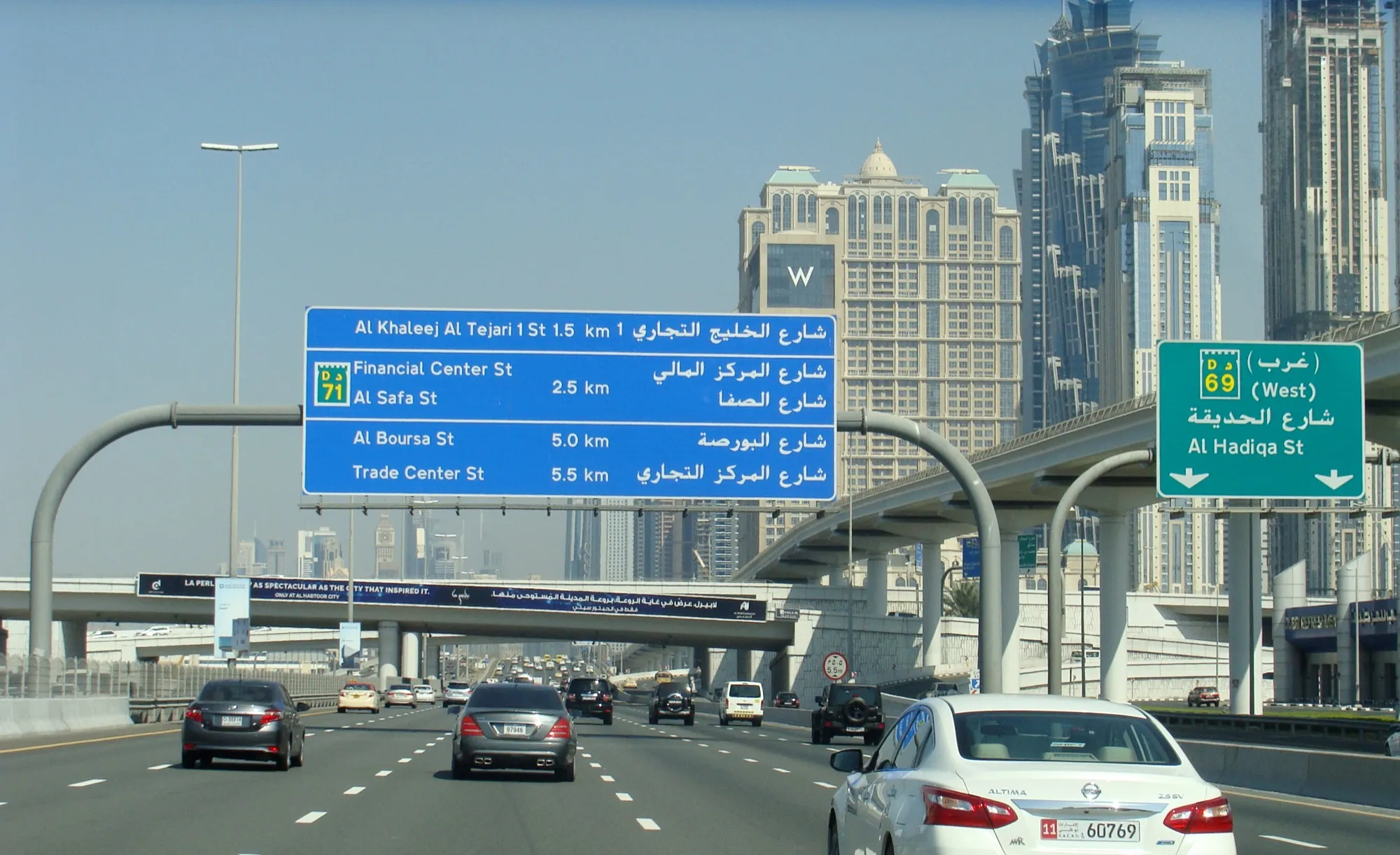Overhead road signs on Sheikh Zayed Road pointing to Financial Centre Street and Al Safa Street