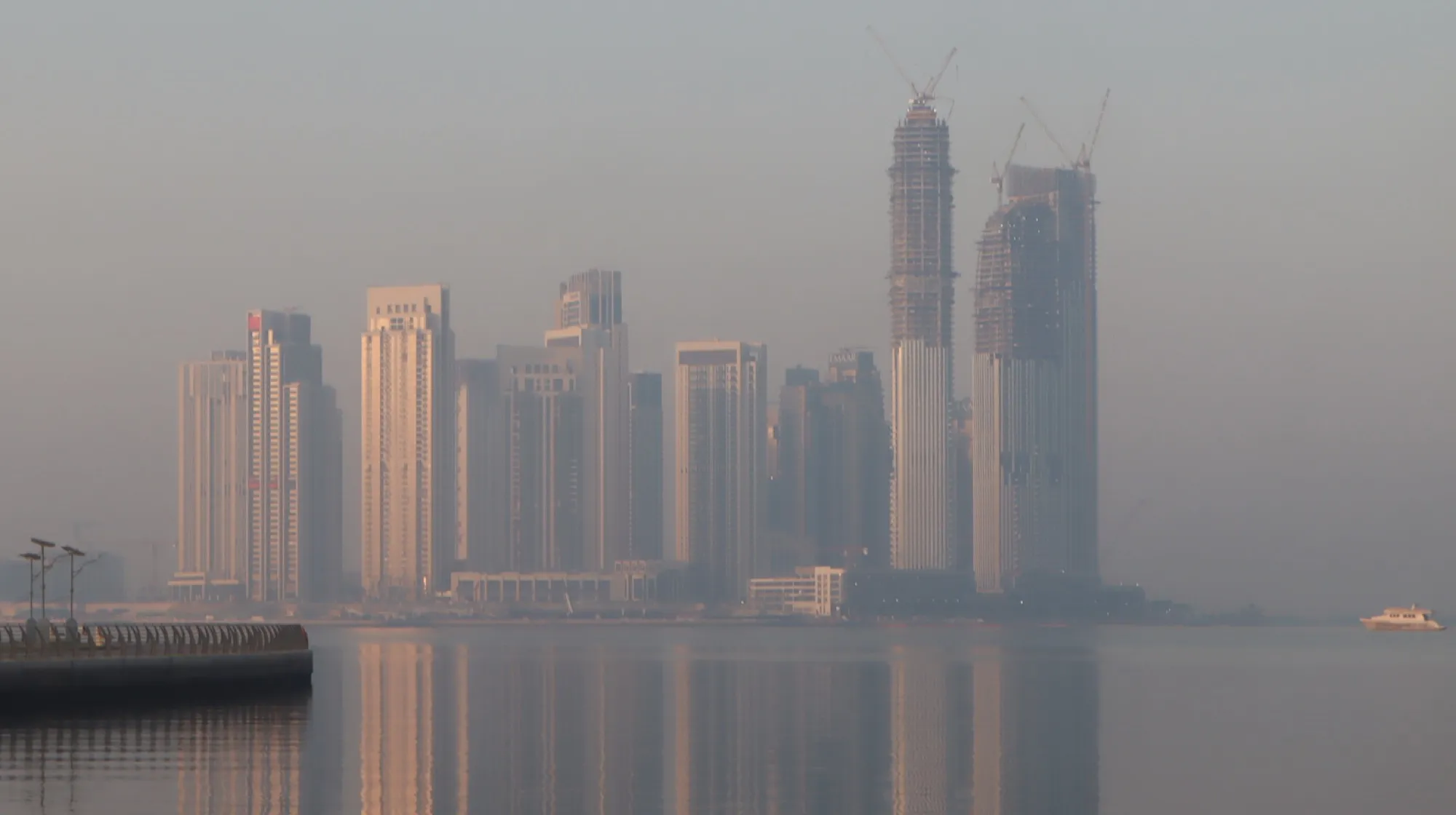 Hazy morning light over the waterfront towers of Dubai Creek Harbour