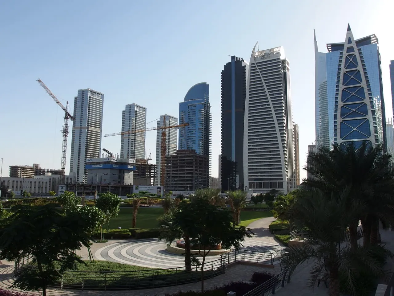 Towers in Jumeirah Lake Towers seen across a landscaped park