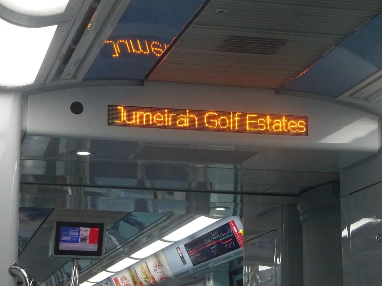 Display inside a Dubai Metro Red Line train showing Jumeirah Golf Estates as the station
