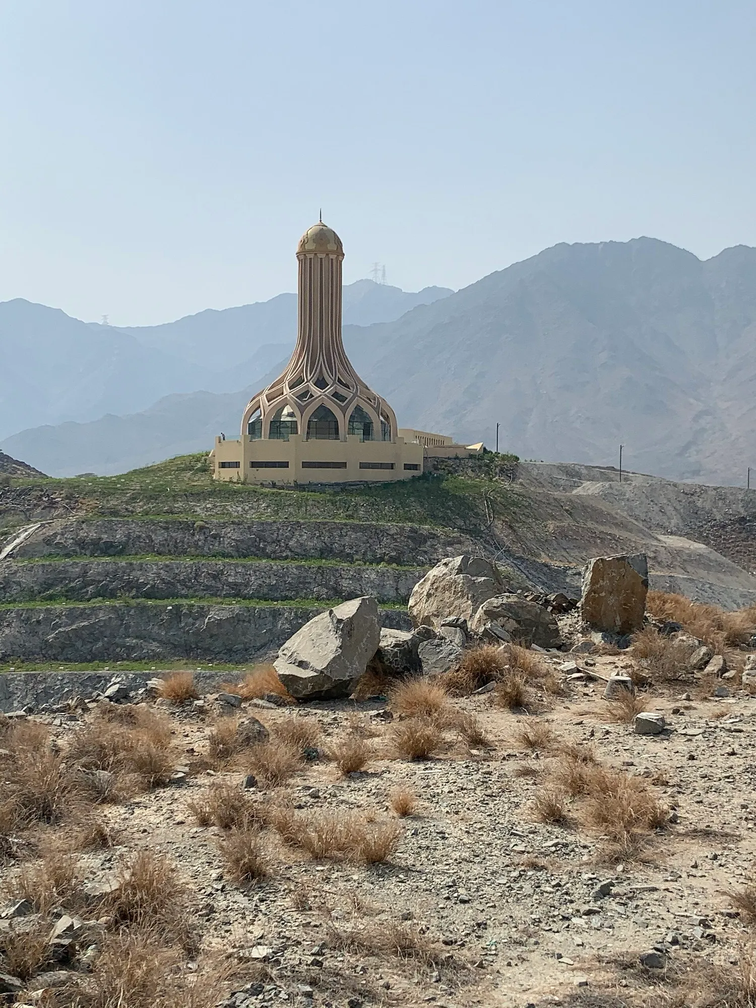 The Khor Fakkan Monument on a hilltop, with the Hajar Mountains behind