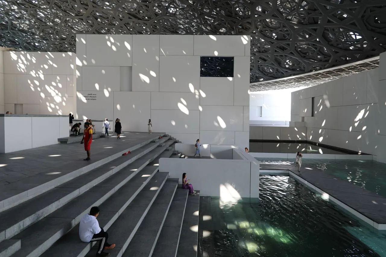 Light falling through the dome of the Louvre Abu Dhabi onto the water below