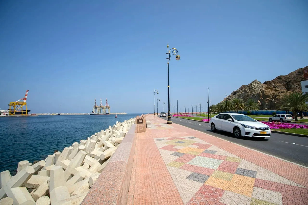 The Muttrah Corniche in Muscat, Oman, with the harbour and mountains
