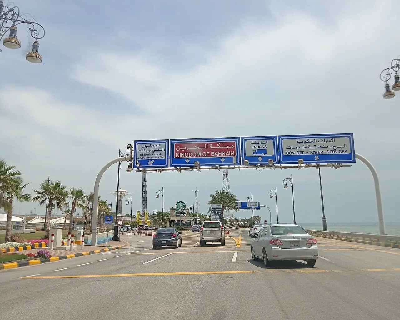 Overhead signs on Passport Island, on the King Fahd Causeway, directing cars into the Kingdom of Bahrain lanes