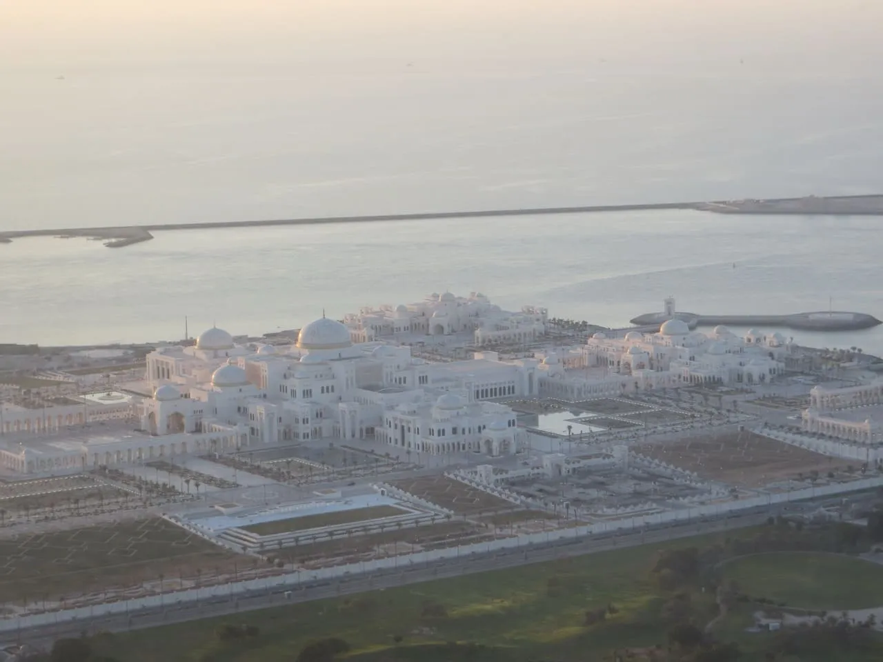 Qasr Al Watan from above, its white domes and gardens beside the sea in Abu Dhabi
