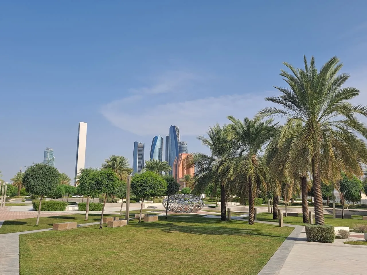 The Abu Dhabi skyline seen from the palm-lined gardens of Qasr Al Watan