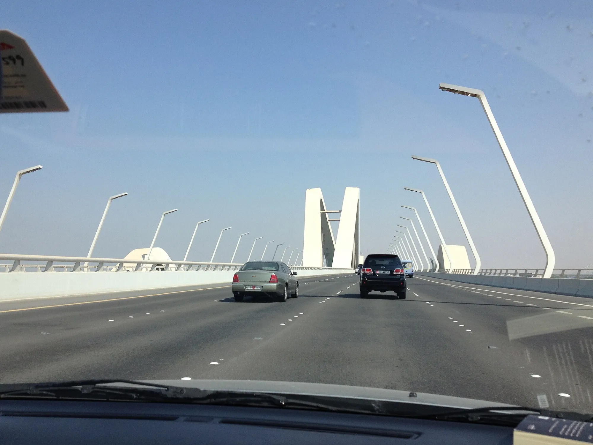 View through a windscreen of cars crossing the Sheikh Zayed Bridge in Abu Dhabi