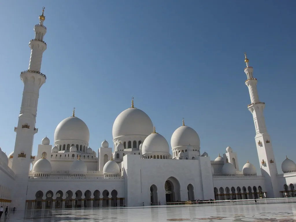 The domes and minarets of the Sheikh Zayed Grand Mosque in Abu Dhabi, seen from the marble courtyard