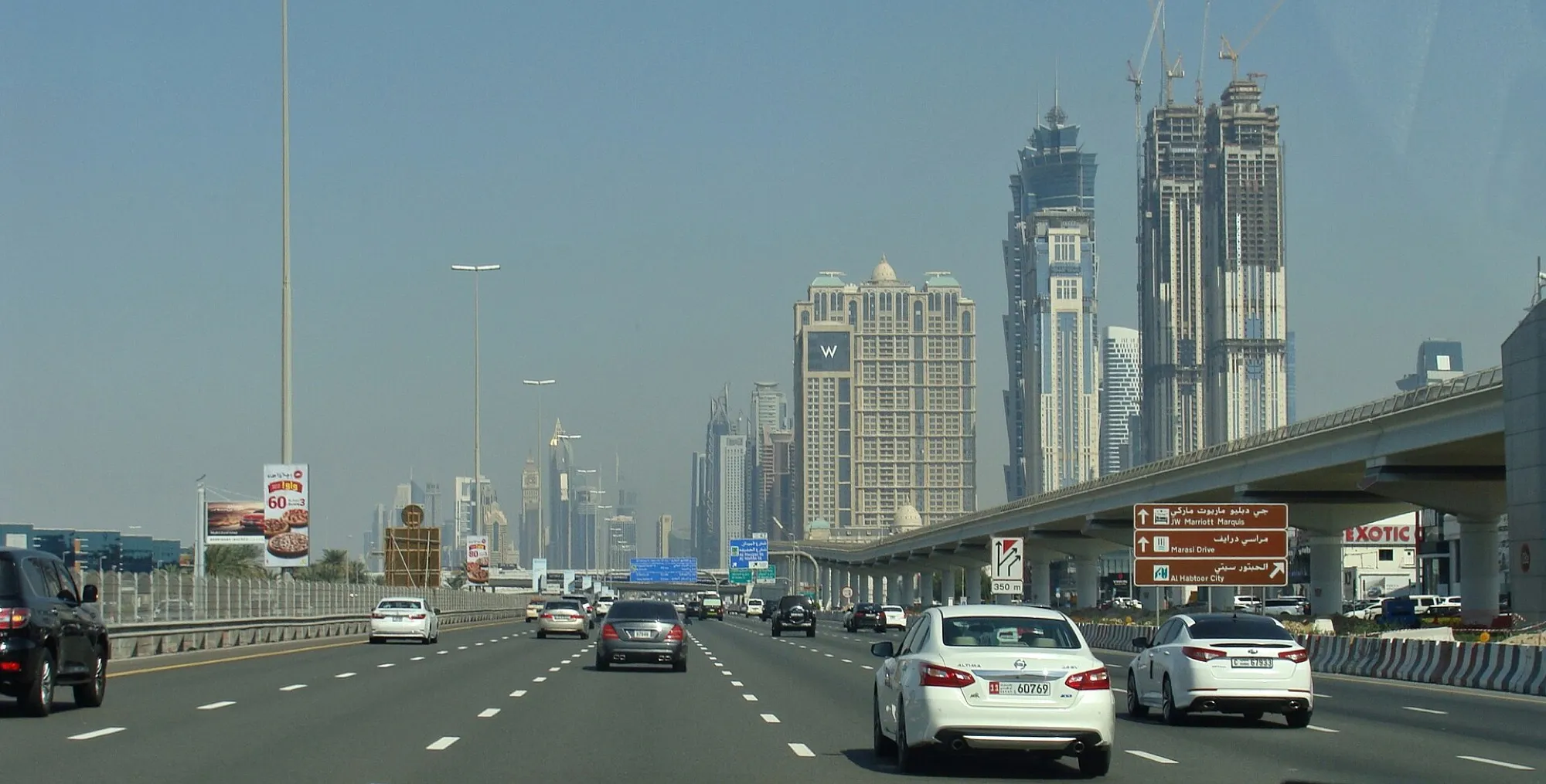 Cars on Sheikh Zayed Road in Dubai heading towards the towers of the Marasi area