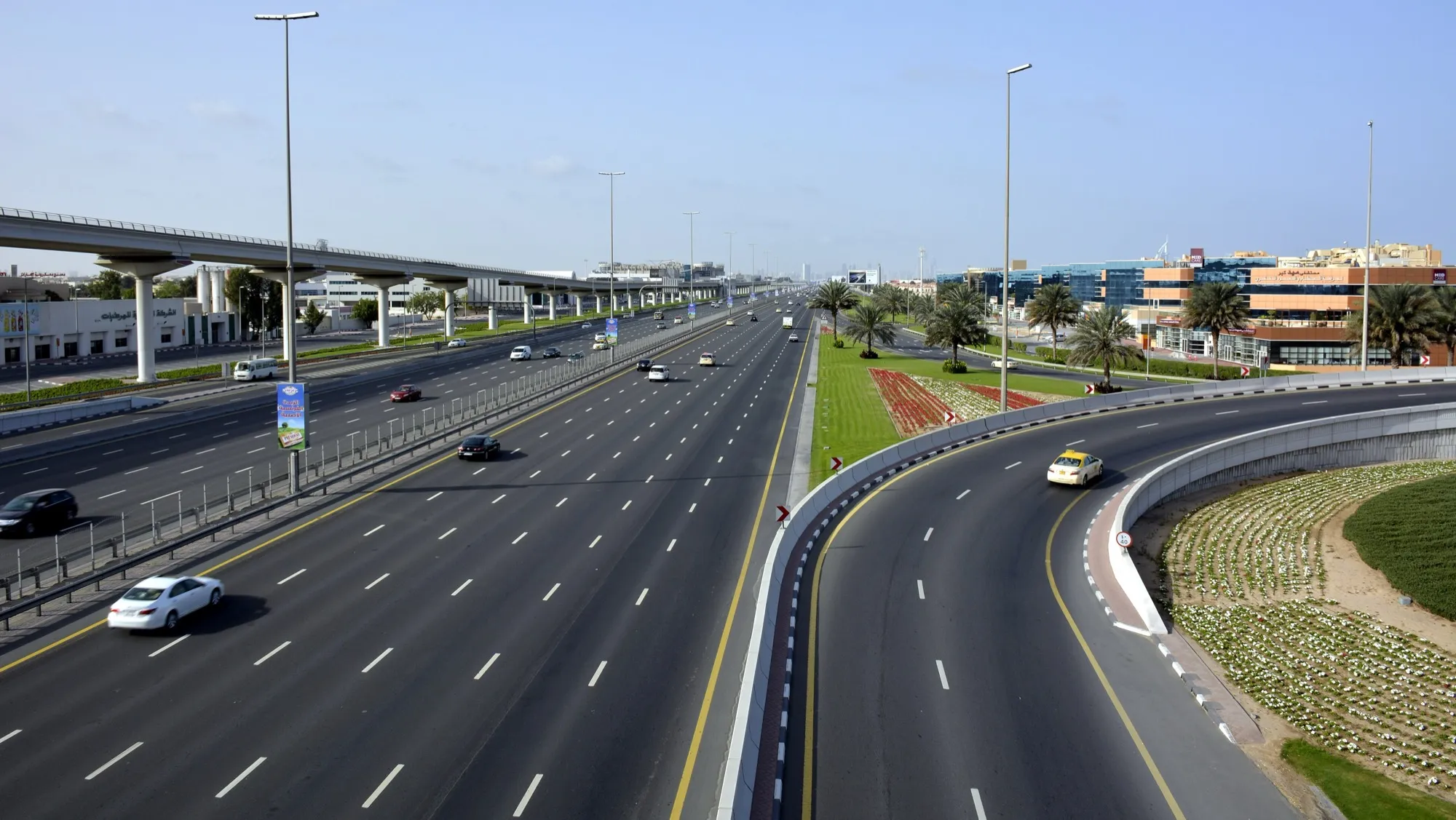 Sheikh Zayed Road in Dubai, a multi-lane highway with the Metro viaduct alongside