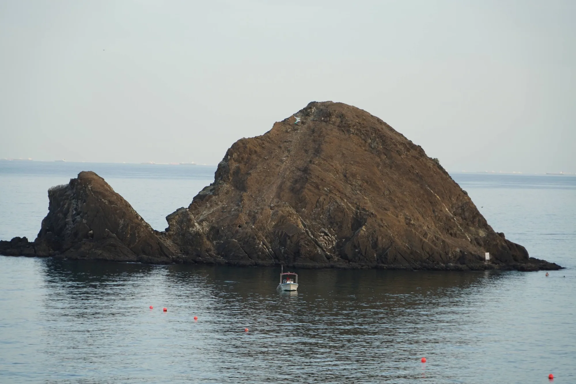 Snoopy Island, a small rocky island off Al Aqah in the Gulf of Oman