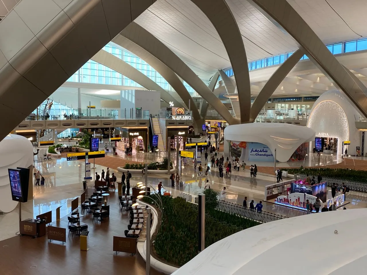 Shops and seating under the arched roof of Terminal A at Zayed International Airport
