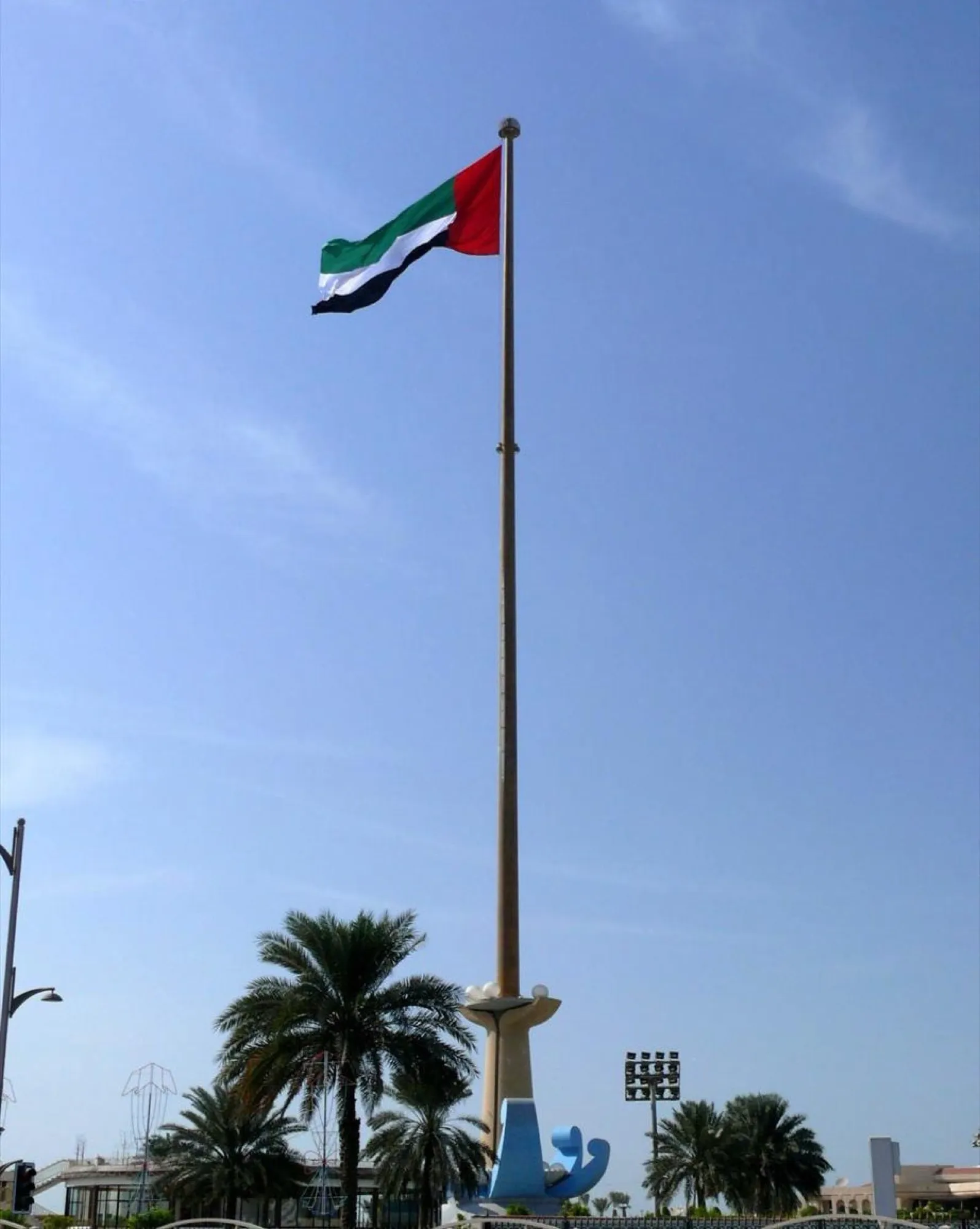 The UAE flag flying from the tall flagpole at Union House in Dubai