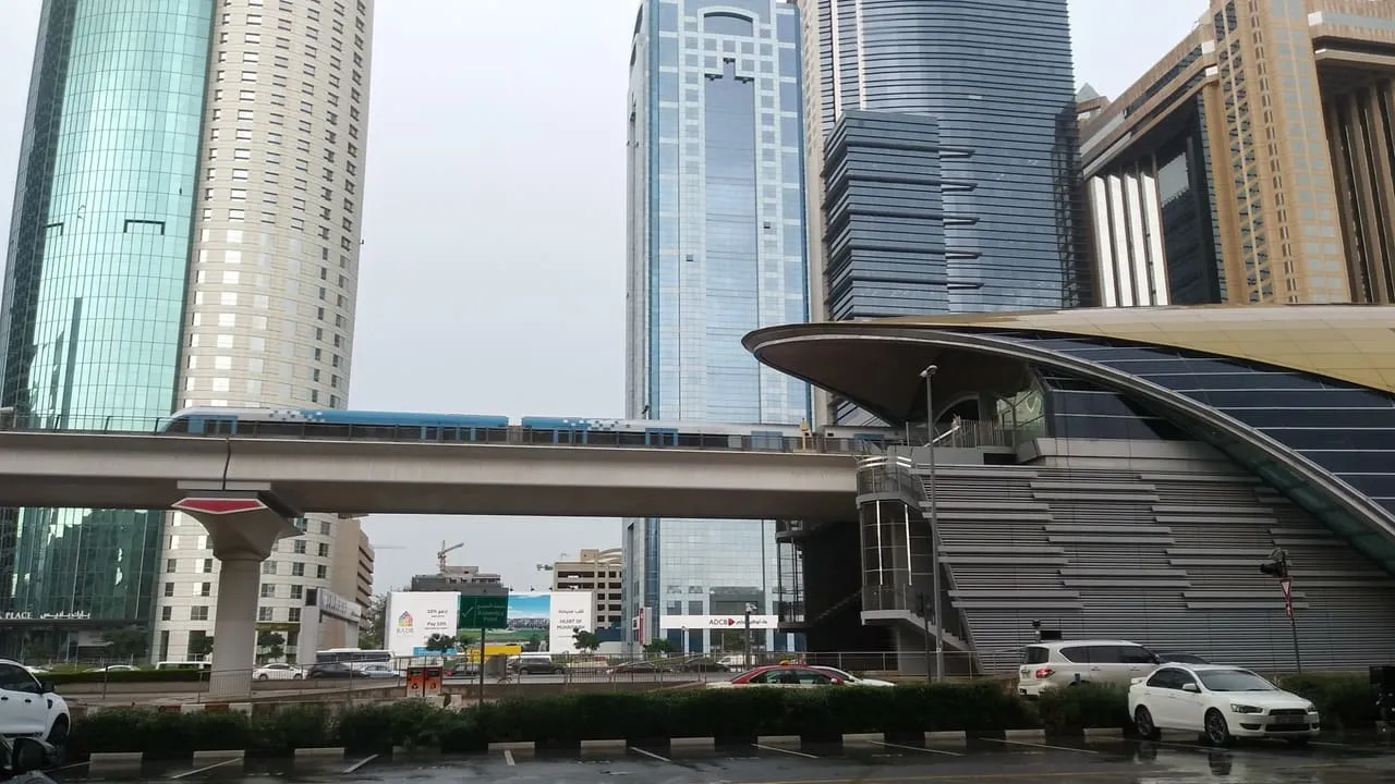 A Dubai Metro Red Line train beside World Trade Centre station on Sheikh Zayed Road